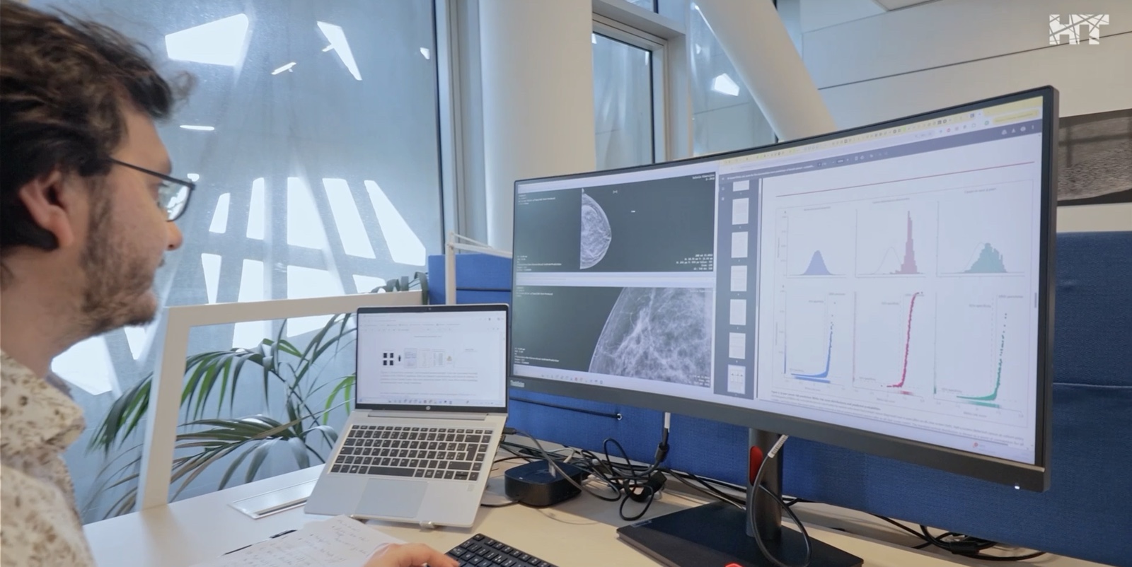 An HT researcher at a multi-monitor workspace
